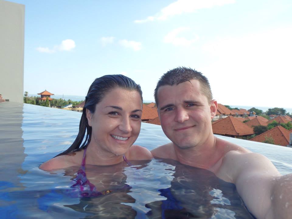 couple posing in a rooftop pool in Seminyak, Bali