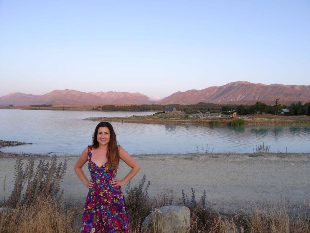 lady at lake tekapo sunset