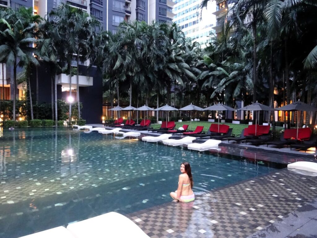 girl posing at outdoor hotel pool KL