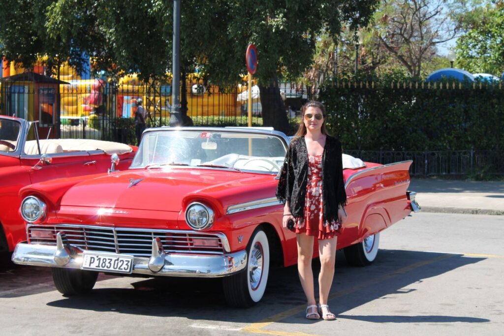 lady posing with classic car havana